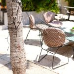 An outdoor patio with chairs and a table.
